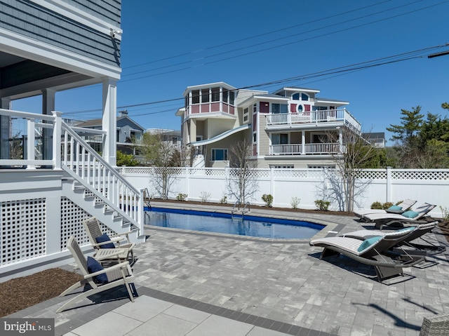 view of pool featuring a fenced backyard, stairs, a patio area, and a fenced in pool