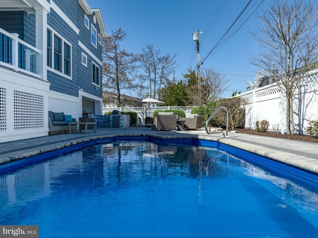 view of swimming pool with a fenced backyard, an outdoor living space, a patio area, and a fenced in pool