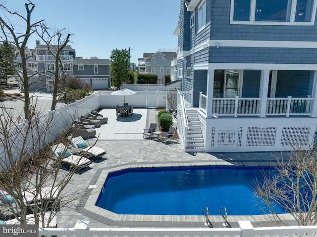 view of pool featuring stairway, a patio area, a fenced backyard, a fenced in pool, and a residential view
