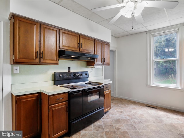 kitchen featuring brown cabinetry, electric range, light countertops, under cabinet range hood, and a ceiling fan