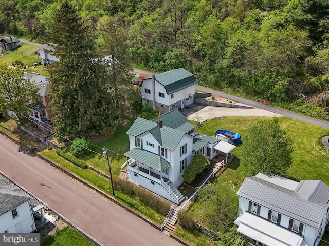 drone / aerial view with a wooded view
