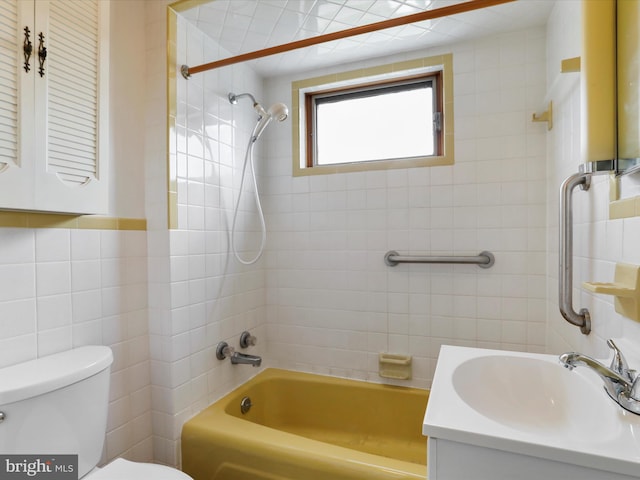 full bathroom with vanity, toilet, tile walls, and bathtub / shower combination