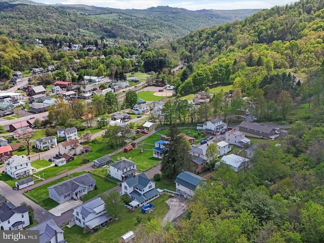 drone / aerial view with a residential view and a wooded view