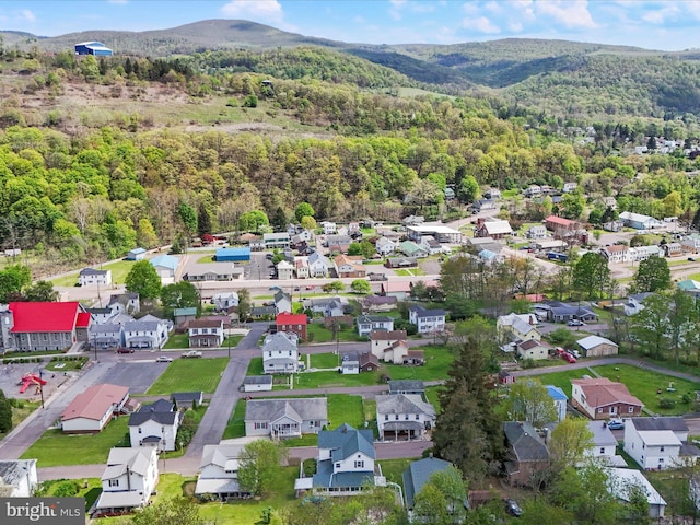 bird's eye view with a residential view, a mountain view, and a wooded view