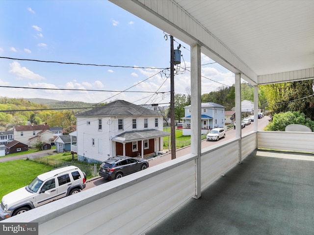 balcony featuring a porch and a residential view