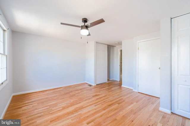 unfurnished room featuring baseboards, a ceiling fan, and light wood-style flooring