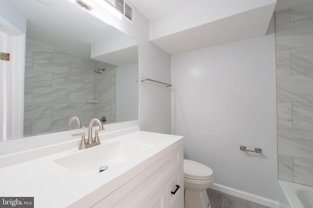 bathroom with toilet, vanity, and visible vents