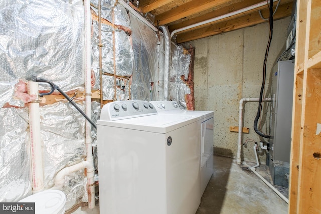 clothes washing area with washer and clothes dryer and laundry area