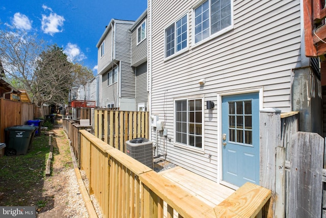 wooden deck with cooling unit and fence