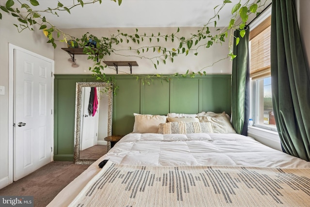 carpeted bedroom featuring a decorative wall