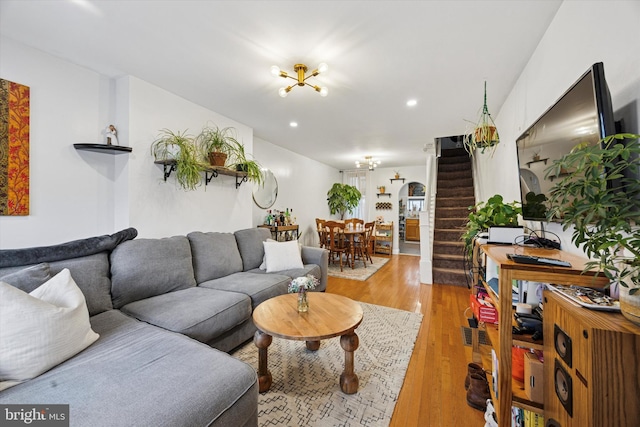 living room with light wood-type flooring, recessed lighting, and stairway