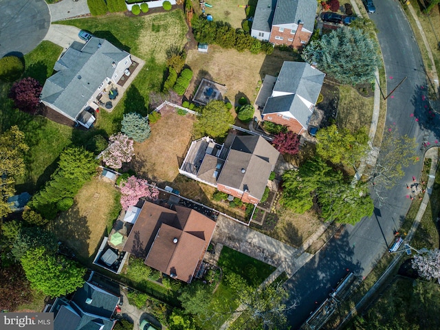 aerial view of property and surrounding area featuring nearby suburban area