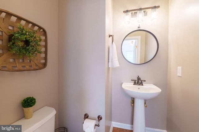 half bath featuring toilet