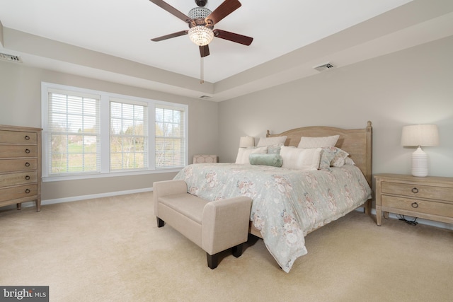 bedroom featuring light carpet, baseboards, and a ceiling fan