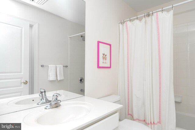 full bath featuring shower / bath combination with curtain, vanity, and toilet
