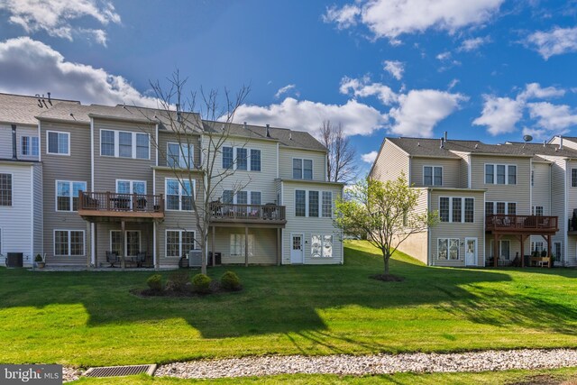 rear view of house featuring a residential view, a yard, and a deck
