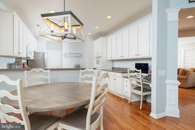 dining room with light wood-style flooring, recessed lighting, and a chandelier