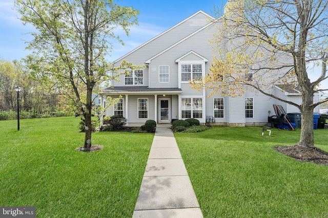 view of front of property featuring a front lawn and covered porch