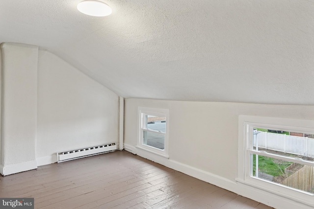 463 New Elm St, Conshohocken, PA 19428 - bonus room featuring baseboards, a textured ceiling, lofted ceiling, and a baseboard heating unit