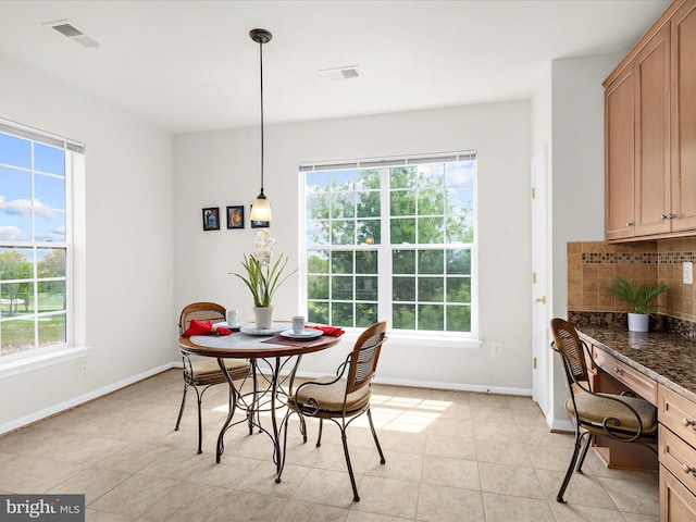 dining space featuring visible vents and a healthy amount of sunlight