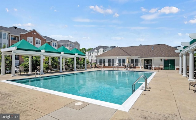 pool featuring a patio and a residential view