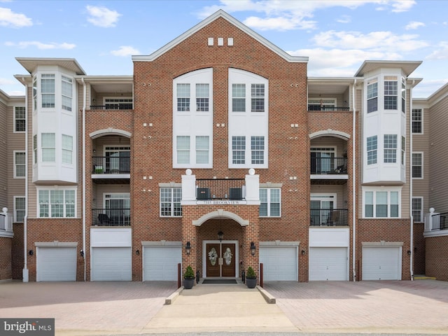 view of property featuring an attached garage and driveway