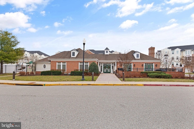 multi unit property featuring brick siding, fence, and french doors