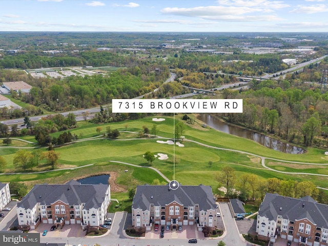 bird's eye view featuring a water view and view of golf course
