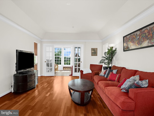 living room featuring crown molding and wood finished floors