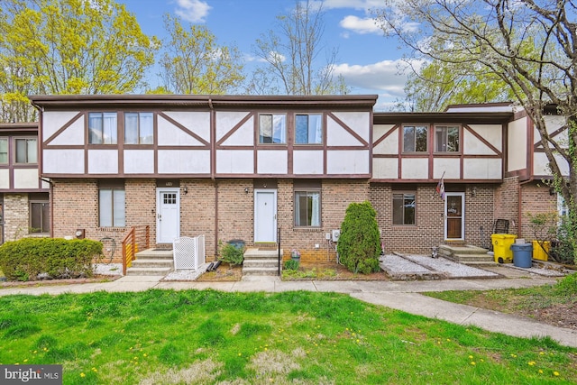 1223 Summerwood Ct, Arnold, MD 21012 - view of front of home with stucco siding, brick siding, and a front yard