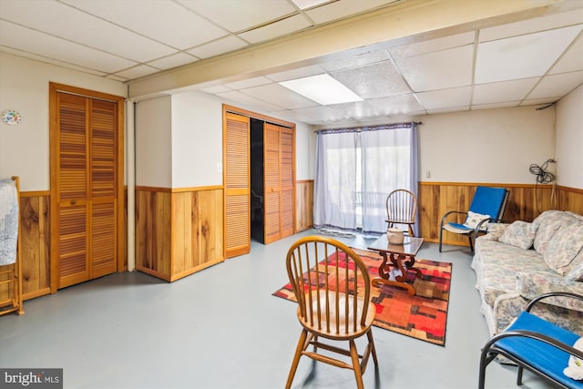 1223 Summerwood Ct, Arnold, MD 21012 - living area with wooden walls, finished concrete flooring, a drop ceiling, and wainscoting