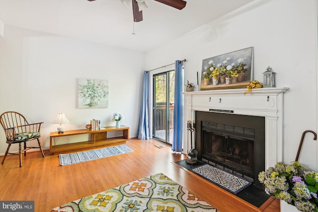 1223 Summerwood Ct, Arnold, MD 21012 - living area featuring a fireplace with flush hearth, a ceiling fan, and wood finished floors