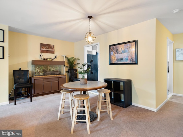carpeted dining area with baseboards and a fireplace