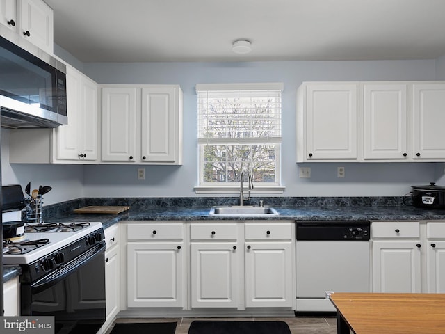 kitchen featuring a sink, white cabinets, dishwasher, stainless steel microwave, and gas stove