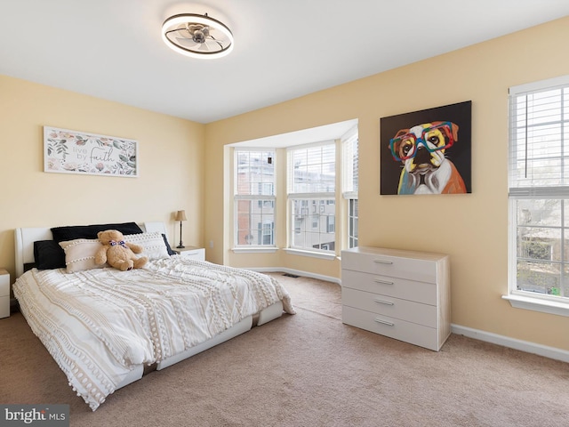 bedroom featuring carpet floors and multiple windows