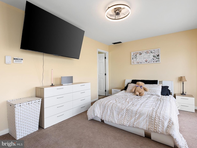 carpeted bedroom featuring baseboards and visible vents