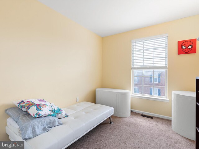 bedroom featuring baseboards, carpet flooring, and visible vents