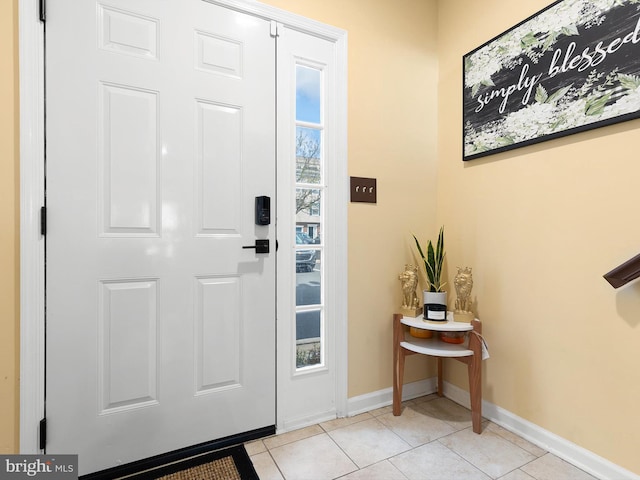 entryway featuring baseboards and light tile patterned floors