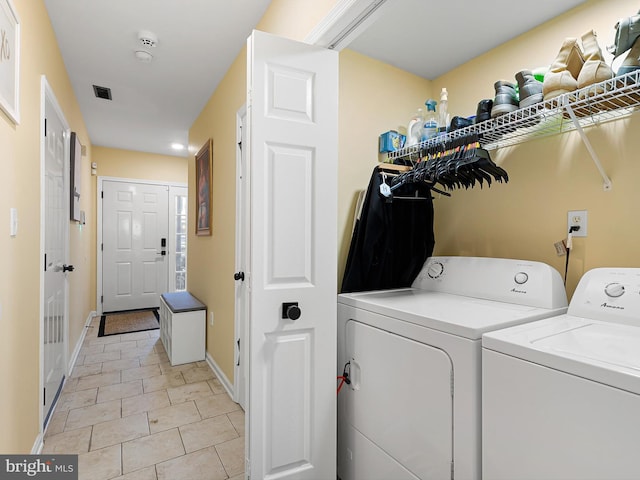 laundry room featuring baseboards, visible vents, independent washer and dryer, laundry area, and light tile patterned floors