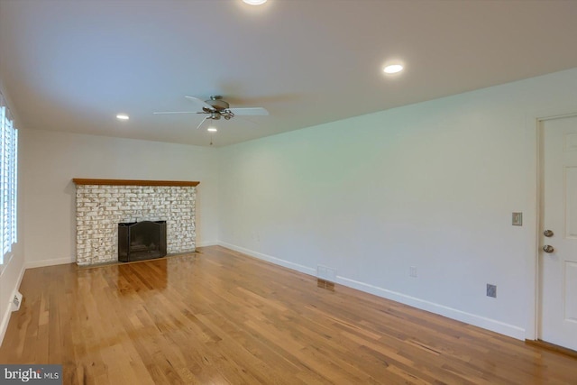 unfurnished living room featuring recessed lighting, light wood-type flooring, baseboards, a fireplace, and ceiling fan