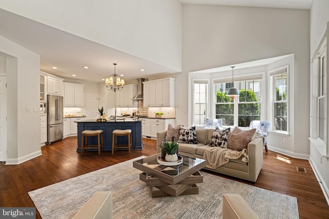 living room with dark wood-style flooring, a chandelier, recessed lighting, baseboards, and visible vents