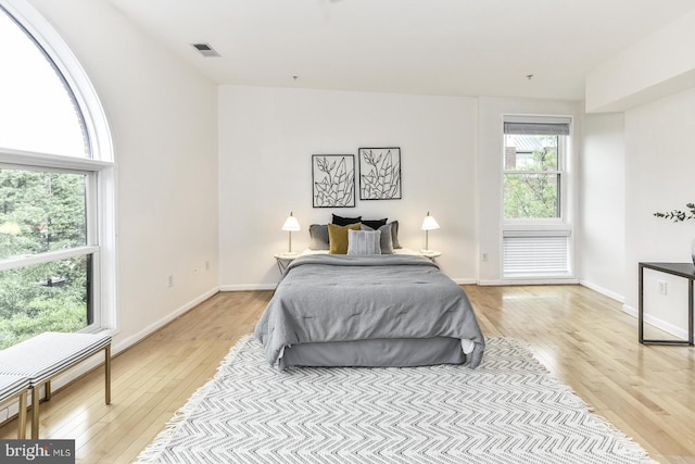 bedroom with light wood-style floors and baseboards