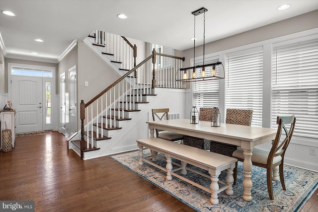 dining room with stairs, crown molding, wood finished floors, and recessed lighting