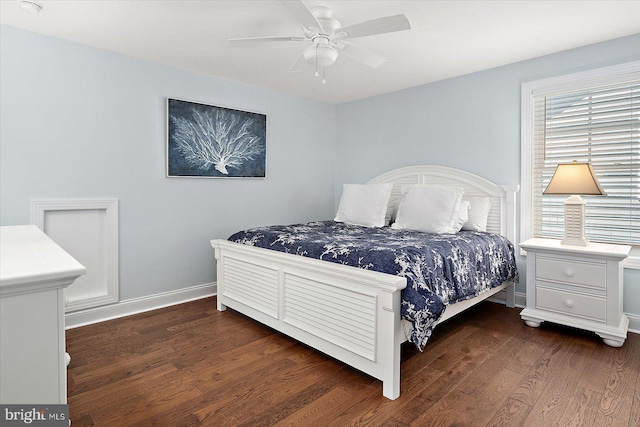 bedroom with wood finished floors, a ceiling fan, and baseboards