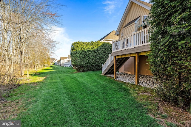 view of yard featuring a wooden deck and stairway