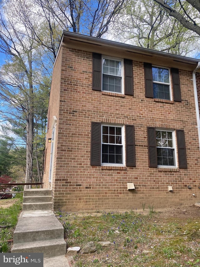 view of side of home with brick siding