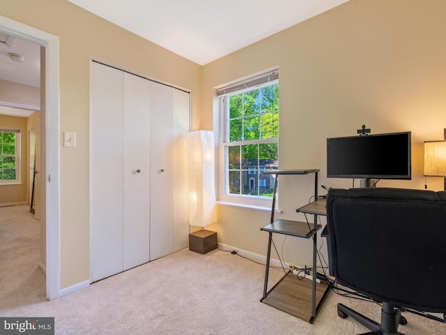 carpeted office featuring baseboards
