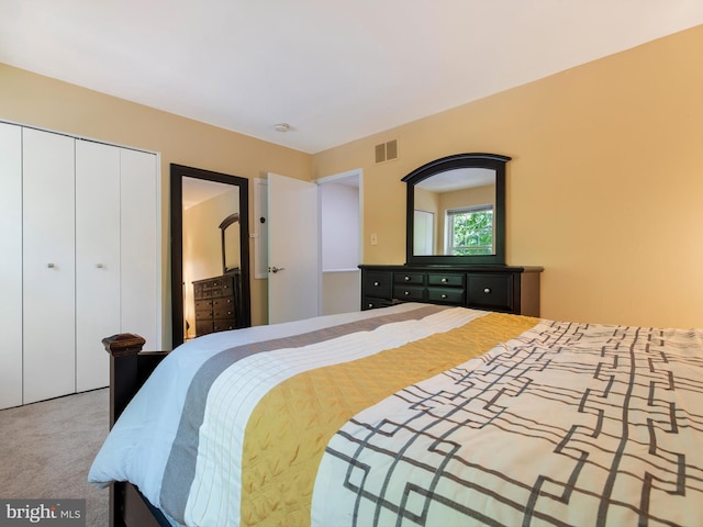 carpeted bedroom featuring a closet and visible vents