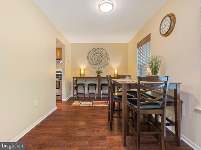 dining room featuring baseboards and wood finished floors