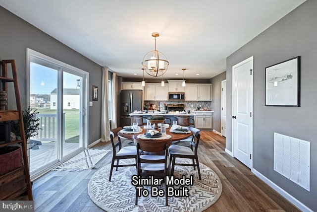 dining room with baseboards, visible vents, a notable chandelier, and dark wood-style flooring